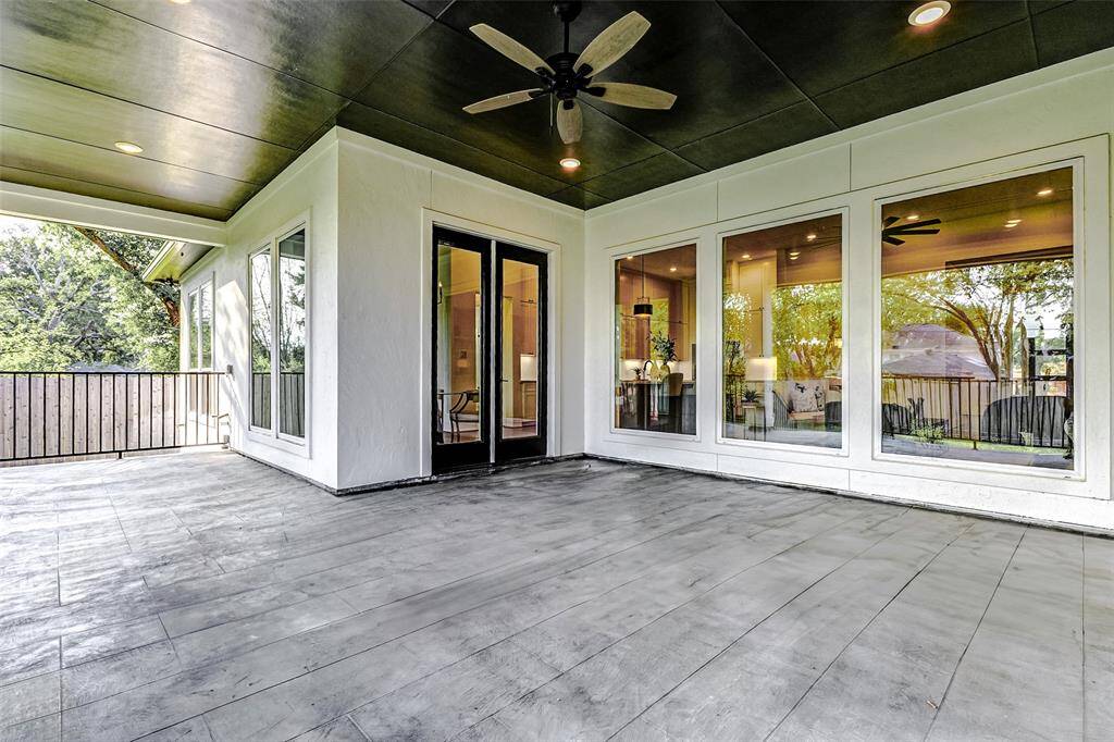 Step outside to your private covered patio, overlooking lush green space and a fully-fenced backyard. The patio is thoughtfully designed with recessed disk lights, a ceiling fan, and elegant wrought iron railing, offering plenty of room to accommodate your favorite outdoor seating or a stylish patio table.