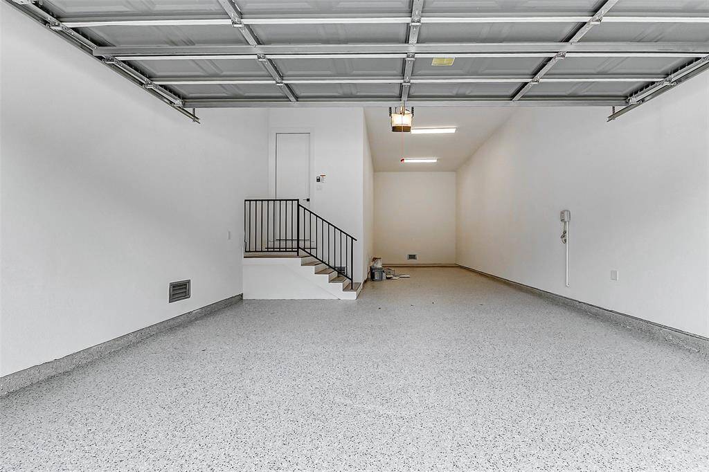 Take a look at the impressive 3-car tandem garage, featuring sleek epoxy flooring for both durability and style.