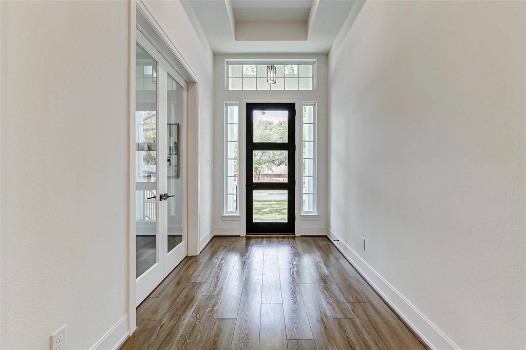 An alternate perspective of the stunning front foyer showcases its elegant design elements and the warm, inviting ambiance that greets you upon entry.