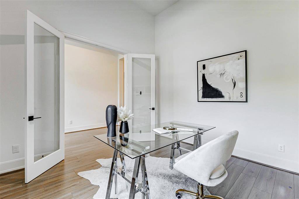 Enclosed by classic French doors, this impressive study offers ample space for large office furnishings.