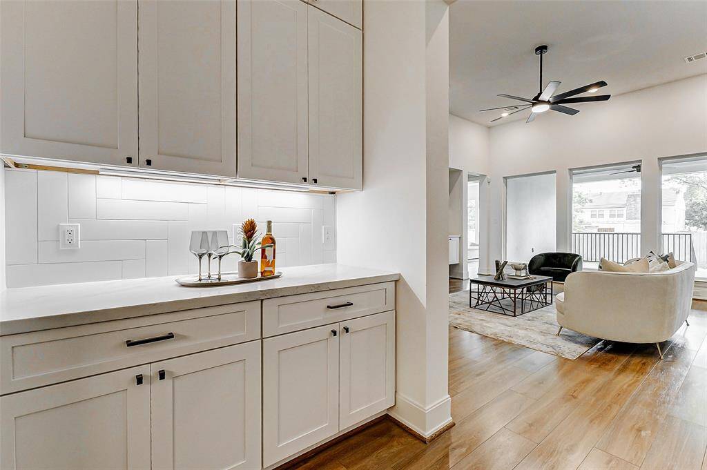 An alternate view of the dry bar reveals its seamless connection to the living area and kitchen, making it an ideal feature for effortless entertaining and flow throughout the home.