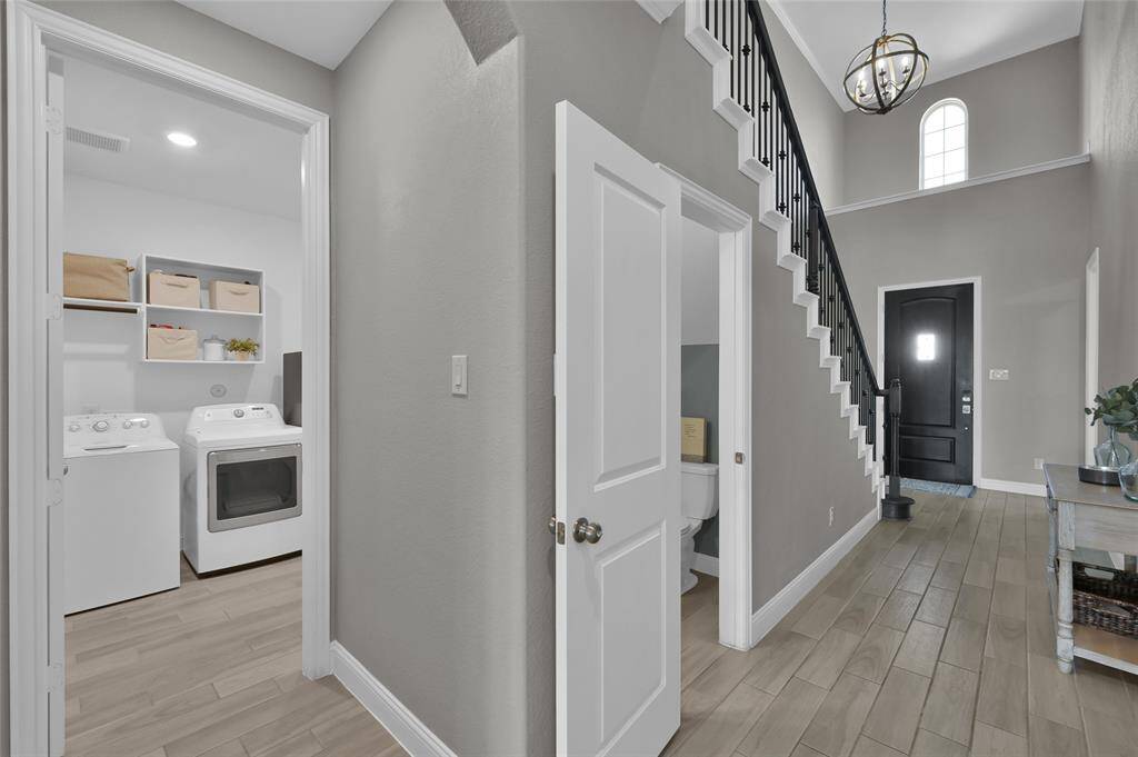 Foyer looking into utility room and powder bathroom