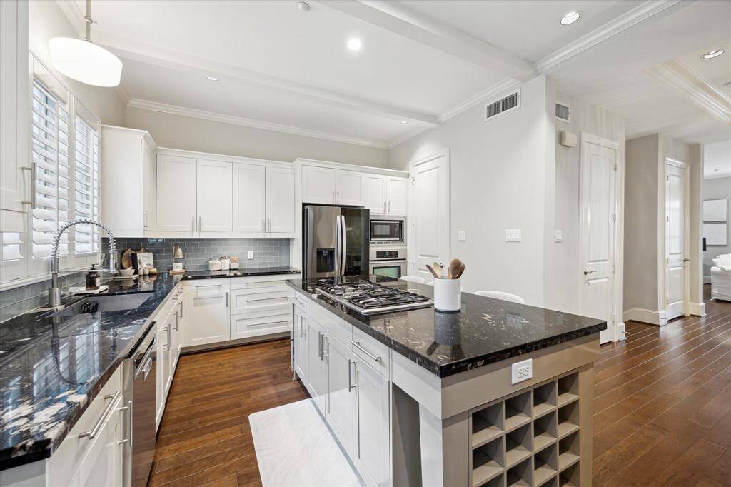 Several cooks could share this space of endless granite countertops.  Storage galore!  The light cabinets make this kitchen feel even brighter and more modern.