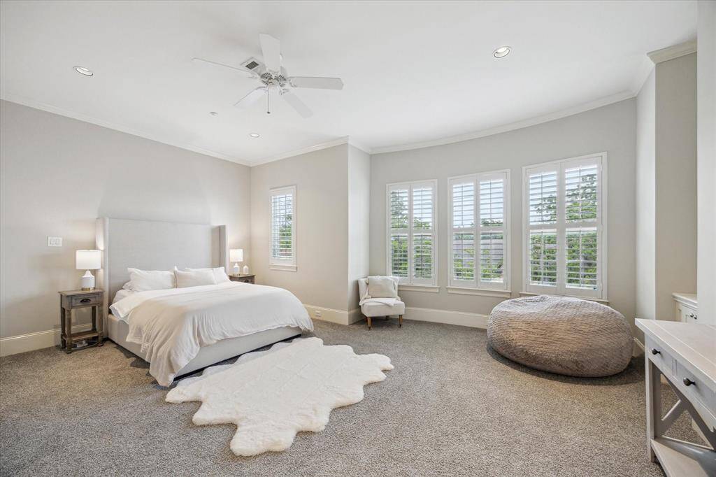 The primary bedroom is massive, and gets showered in light coming from a wall of windows.
