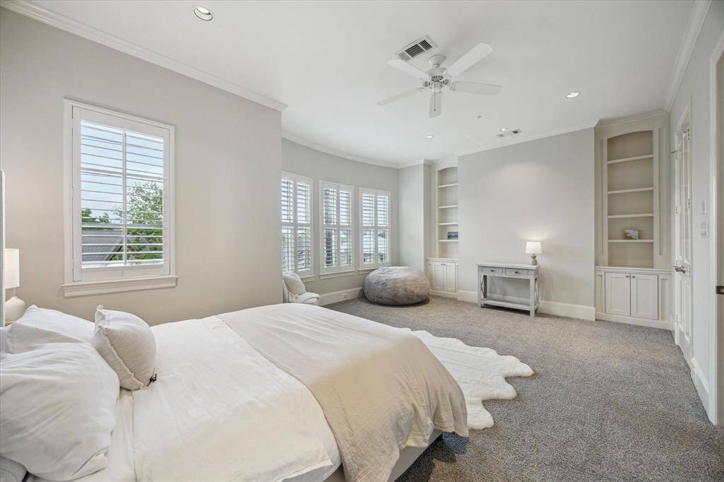 This primary bedroom is grand, elegant and roomy.