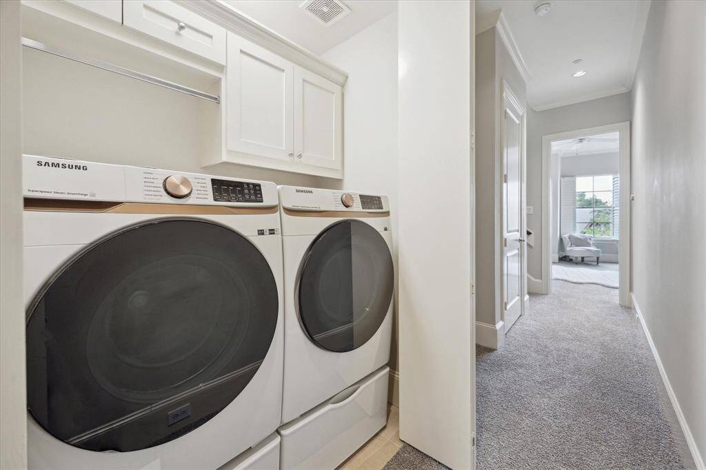 Laundry room on the same floor as the primary bedroom.