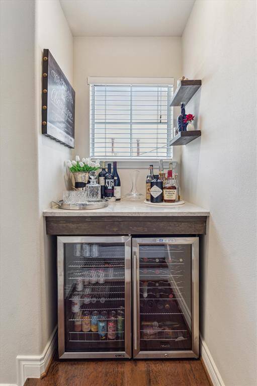 Recently installed dry bar with Taj Mahal quartzite countertop, with double stainless steel beverage refrigerators.