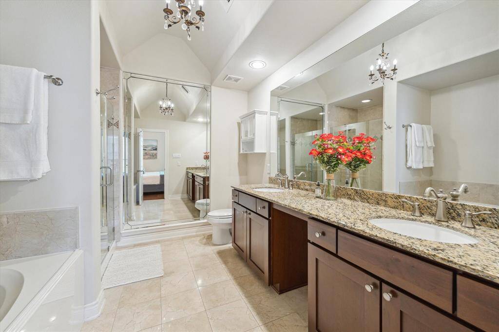 Primary bathroom with a dual sink vanity and large full-length mirror.