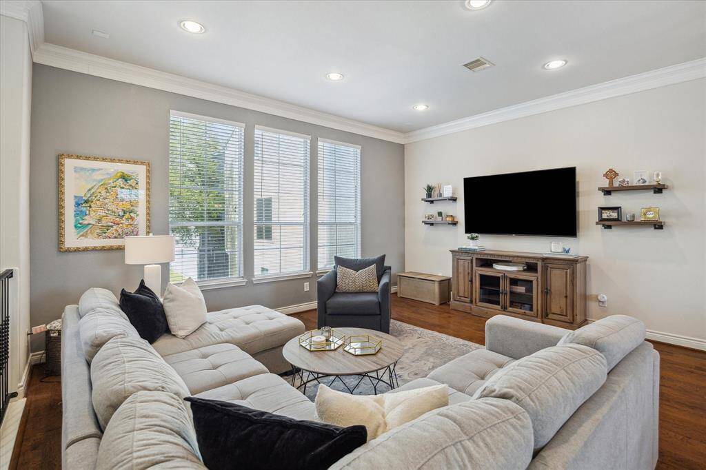 Open second-floor living with engineered hardwood, crown molding, and recessed lighting throughout. Large windows fill the space with natural light!
