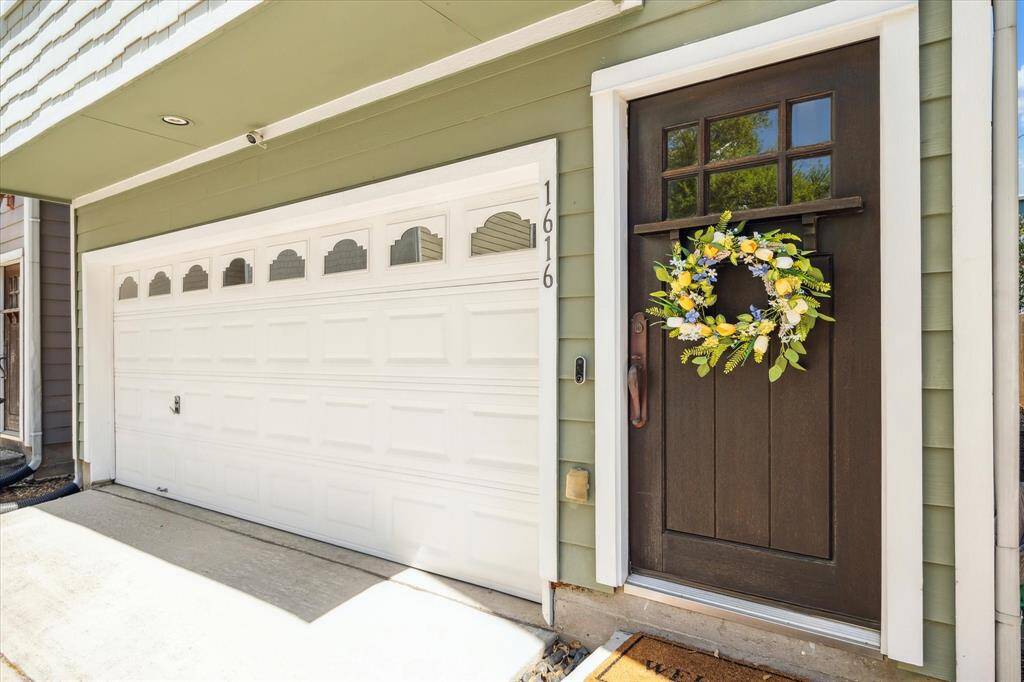 Warm & inviting entrance! This home features a two-car garage with ample parking and extra storage space.