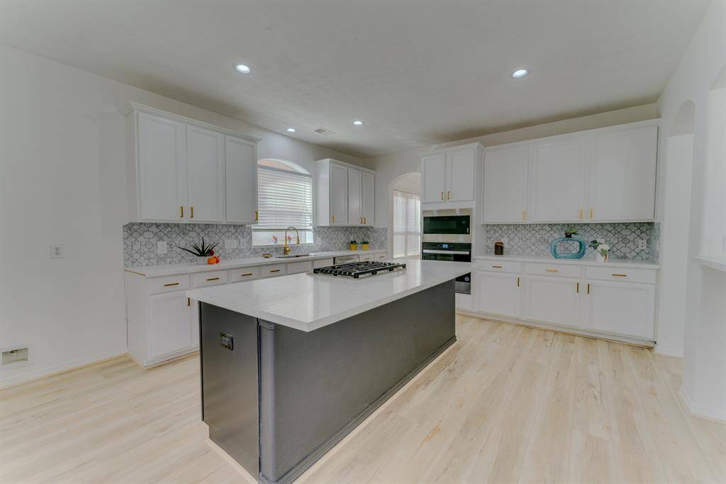 Beautiful fully remodeled & updated kitchen with quartz countertops and gold hardware and fixtures
