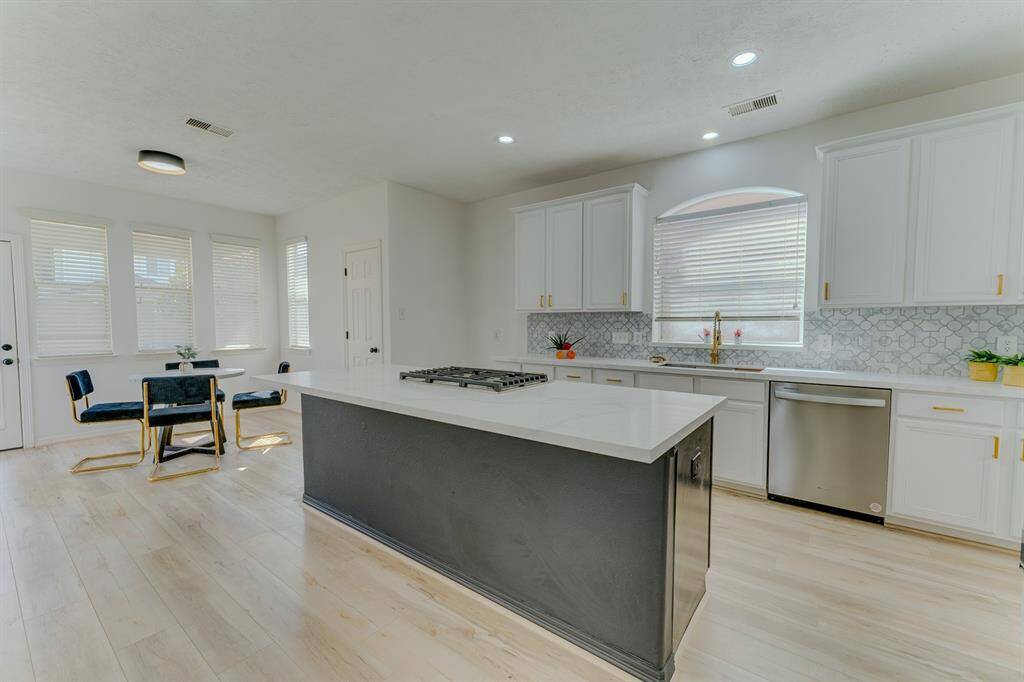 Beautiful fully remodeled & updated kitchen with quartz countertops and gold hardware and fixtures