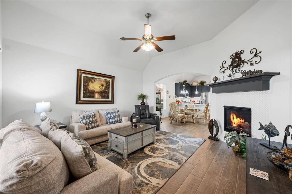 Spacious living area featuring a mock fireplace with ornate tile-work.