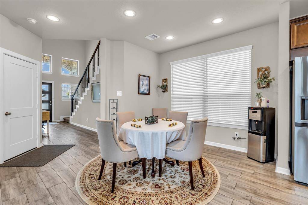 Thoughtfully positioned to flow seamlessly from the kitchen and living area, this room features ample space, great lighting, and a layout that makes entertaining effortless.
