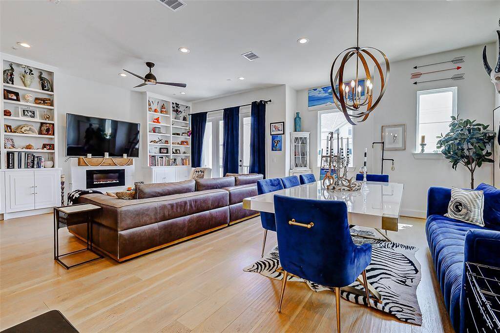 Light-filled and open, the spacious living area features custom built-in bookshelves, a cozy fireplace, and direct access to a private balcony—perfect for everyday comfort or entertaining.