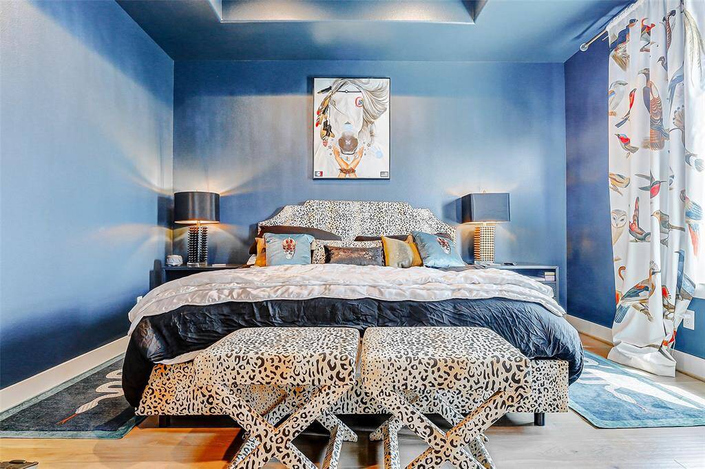 Located on the third floor, the tranquil blue primary bedroom features engineered wood flooring, soft natural light, and a spacious layout—offering a peaceful retreat with spa-inspired en suite bath and designer finishes.