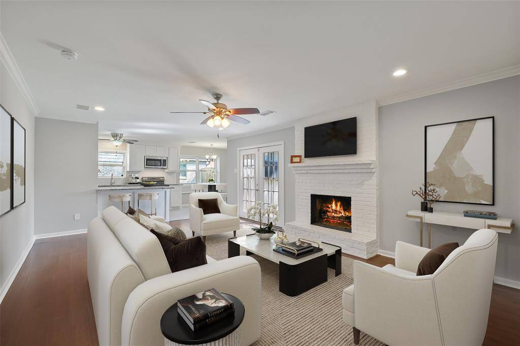 Another view of the family room showing how it seamlessly opens to the kitchen and breakfast area, ideal for entertaining and everyday life. Note: this photo has been virtually staged.