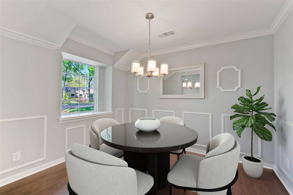 Elegant formal dining room, perfectly located with seamless access to both the formal living room and kitchen. With a spacious breakfast area on the opposite side, this room offers versatile potential; could also make an ideal home office or playroom. Features include: engineered hardwood floors, a large window with a ledge overlooking the front yard, a decorative light fixture, wainscoting, and a beautiful decorative mirror, included. Note: this photo has been virtually staged.