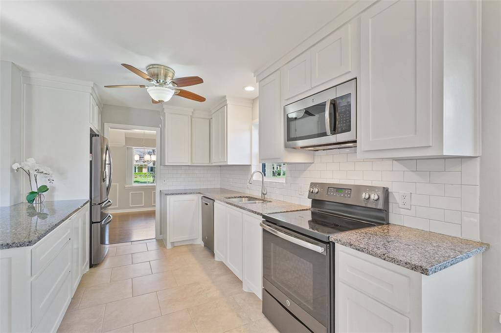 This fabulous kitchen is designed for both everyday living and entertaining, seamlessly opening to the breakfast room, formal dining room, and family room. Custom-made on-site cabinetry, granite countertops, and a white subway tile backsplash create a stylish space. There is a large breakfast bar that opens to the family room.