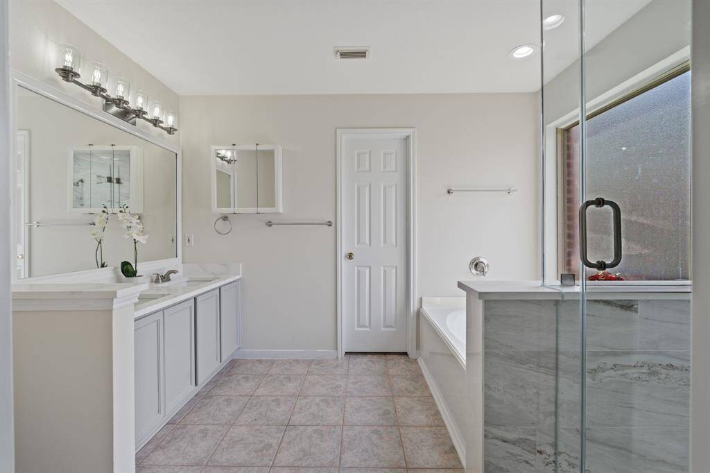 This is such an inviting and beautifully remodeled primary bathroom!