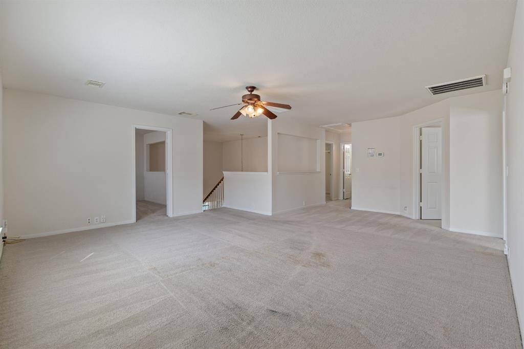 A view of the flex space looking towards the office, stairway, bedroom and full bathroom.