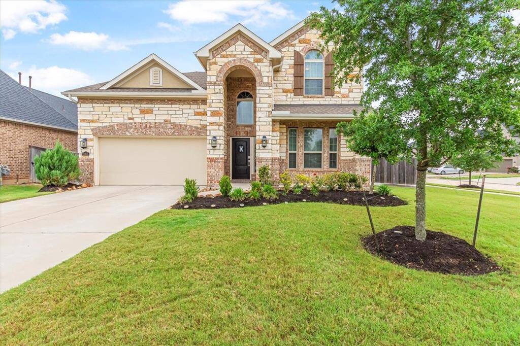 Beautiful curb appeal with inviting front porch and corner lot