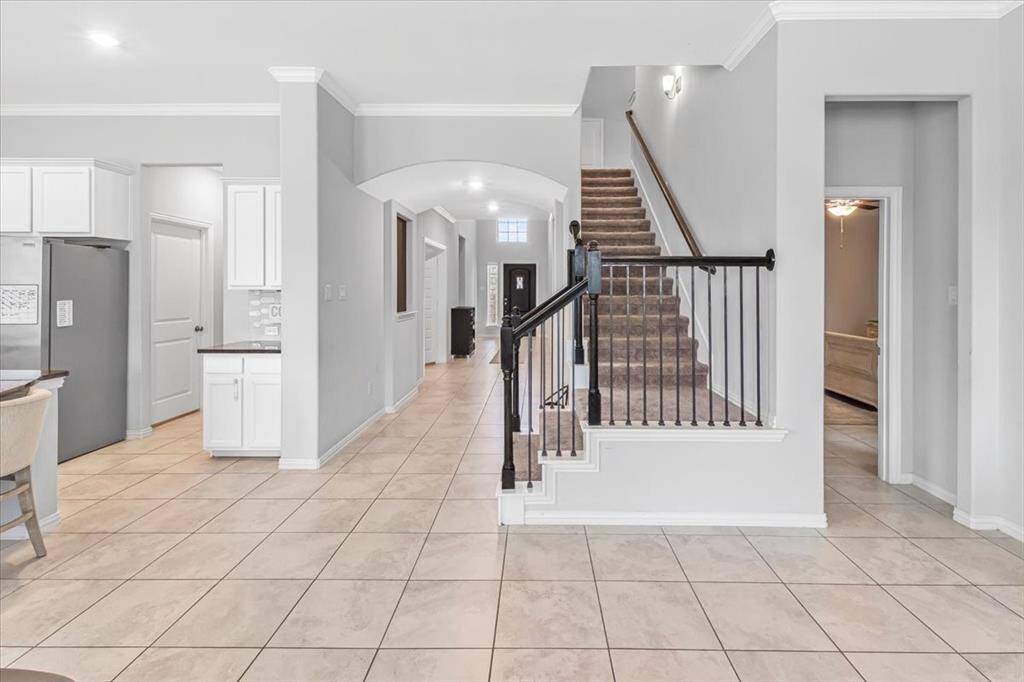 Open-concept family room with abundant natural light, seamlessly connected to kitchen and dining
