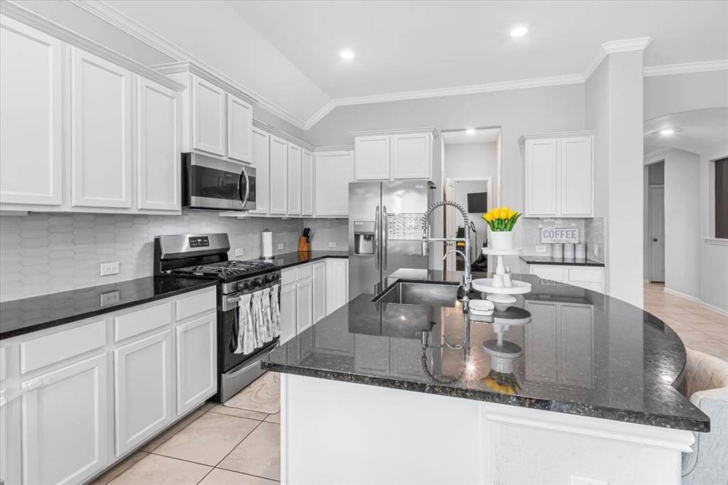 Chef-inspired kitchen with island, walk-in pantry, and modern finishes