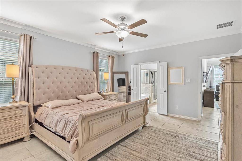 Spacious primary retreat with natural light and en-suit bath, located on the first floor.