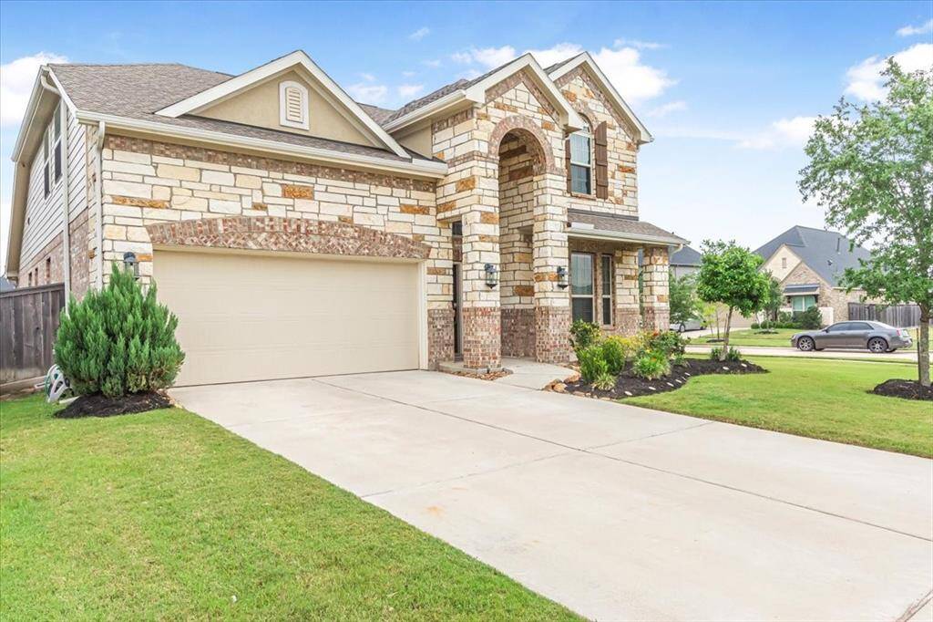 Beautiful curb appeal with inviting front porch and corner lot