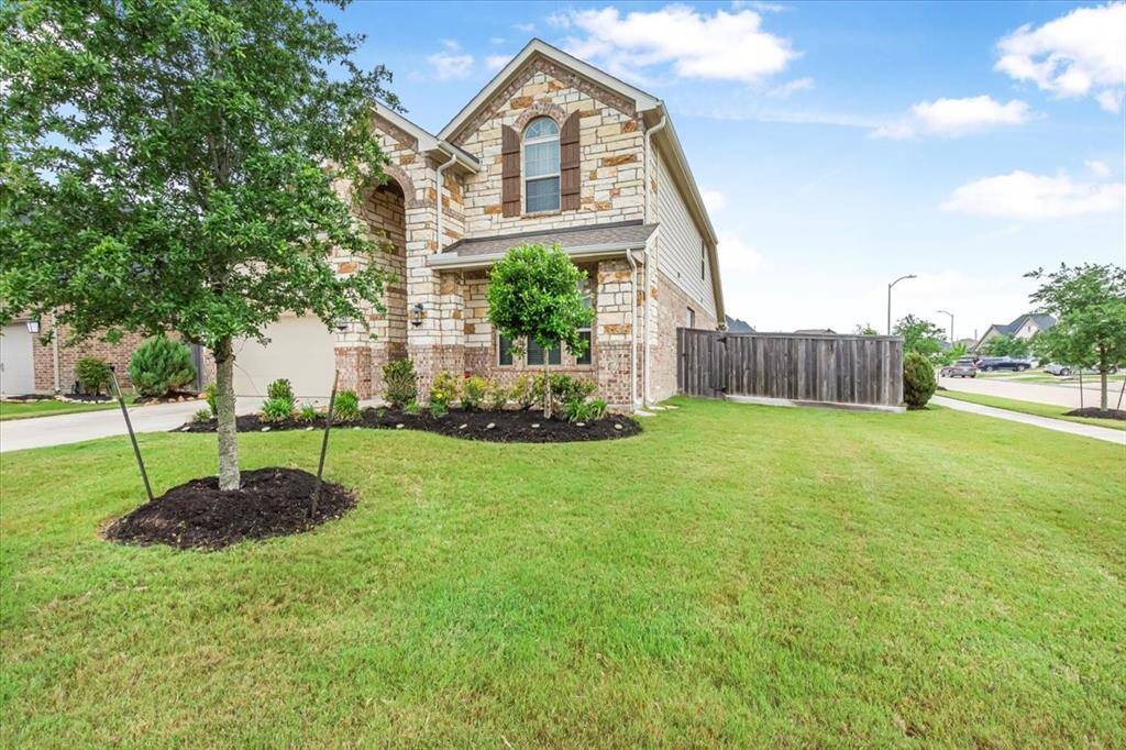 Beautiful curb appeal with inviting front porch and corner lot