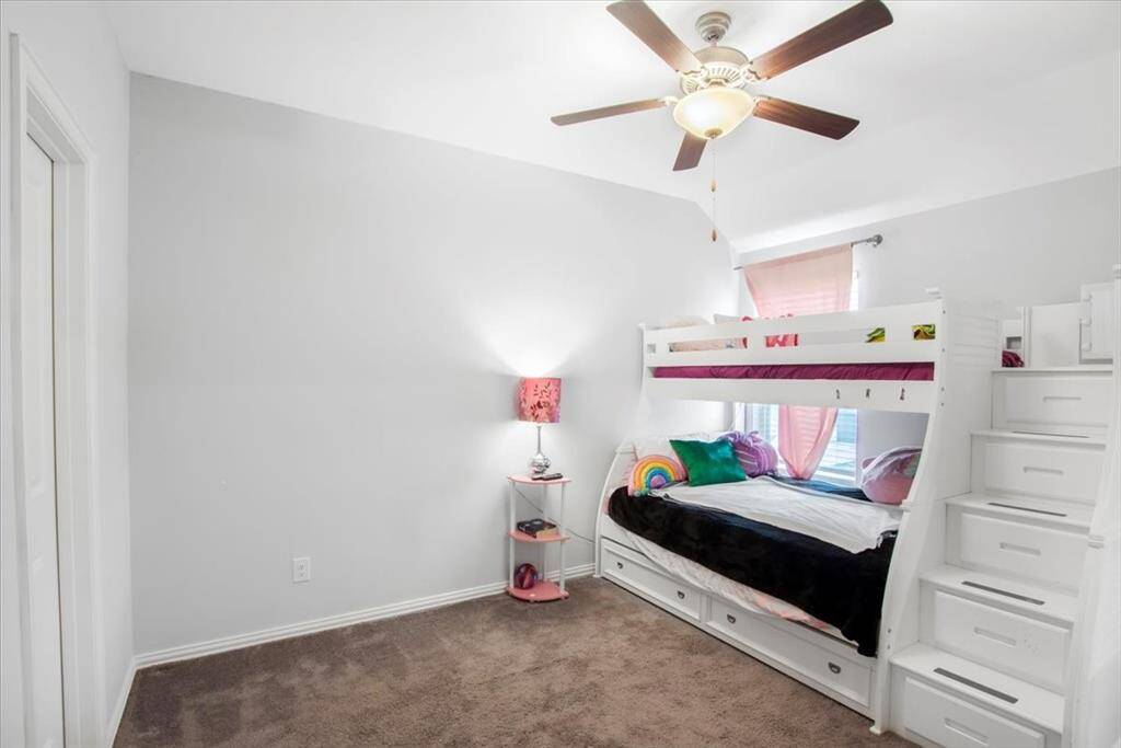 Spacious upstairs 4th bedroom with large window and walk in closet connected to Jack and Jill bathroom.