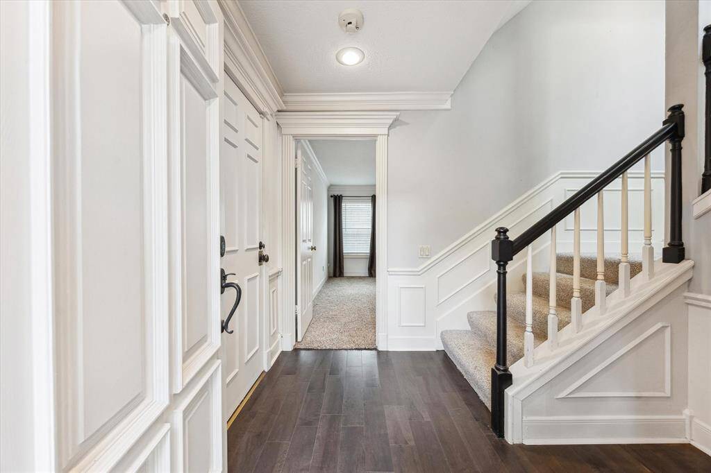 The home exudes character from the moment you step inside the inviting entryway and discover a thoughtfully designed floor plan. The foyer with large closet and a staircase with black handrail leads up to the 2nd floor living areas.