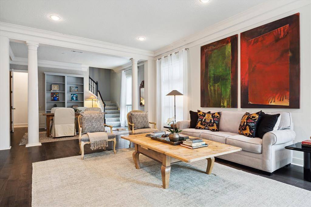 The living room features elegant columns that create a distinction between the formal living room and dining room.