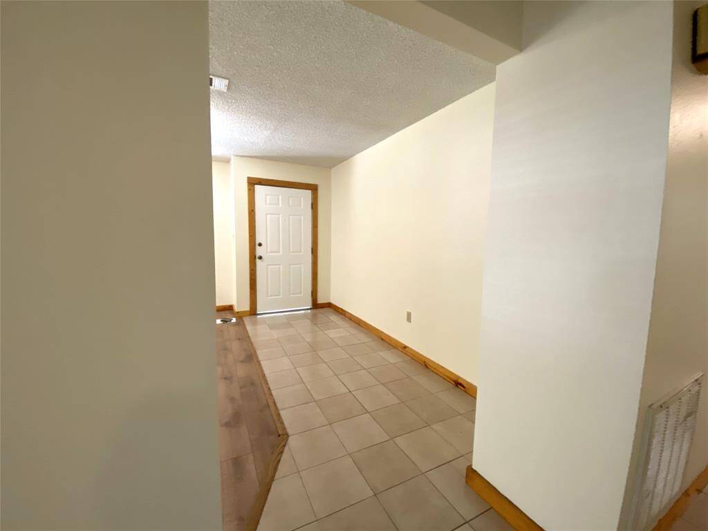 Looking to the front door from the hallway.