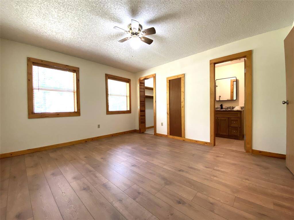 Primary bed room with walk in closet and ensuite bathroom.