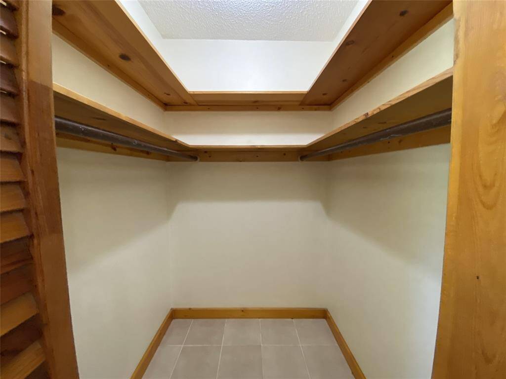 Walk in closet in primary bedroom.