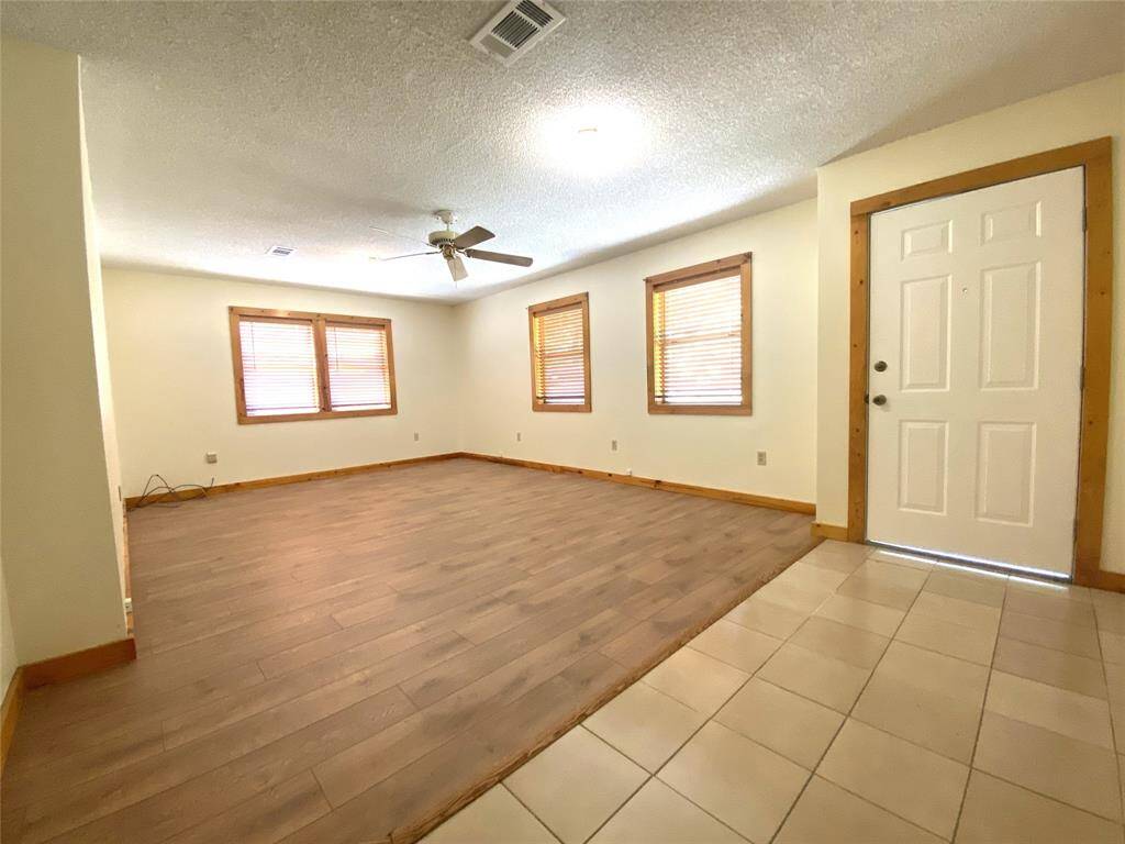 Another view of the living room and front door.