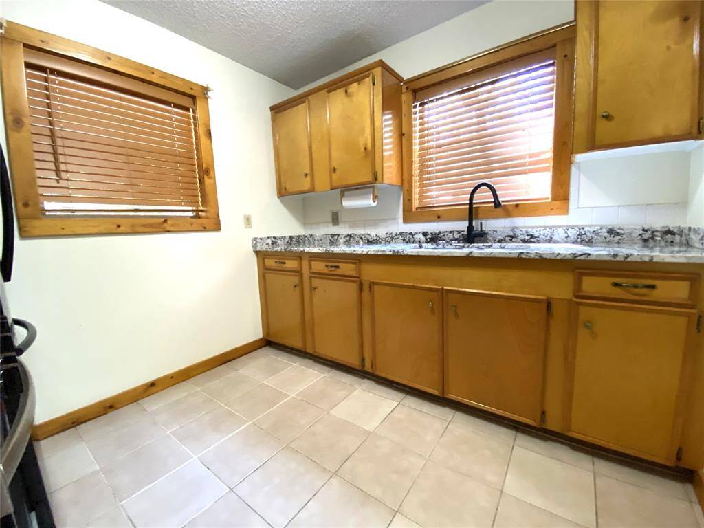 Kitchen has views of the back yard and side yard.