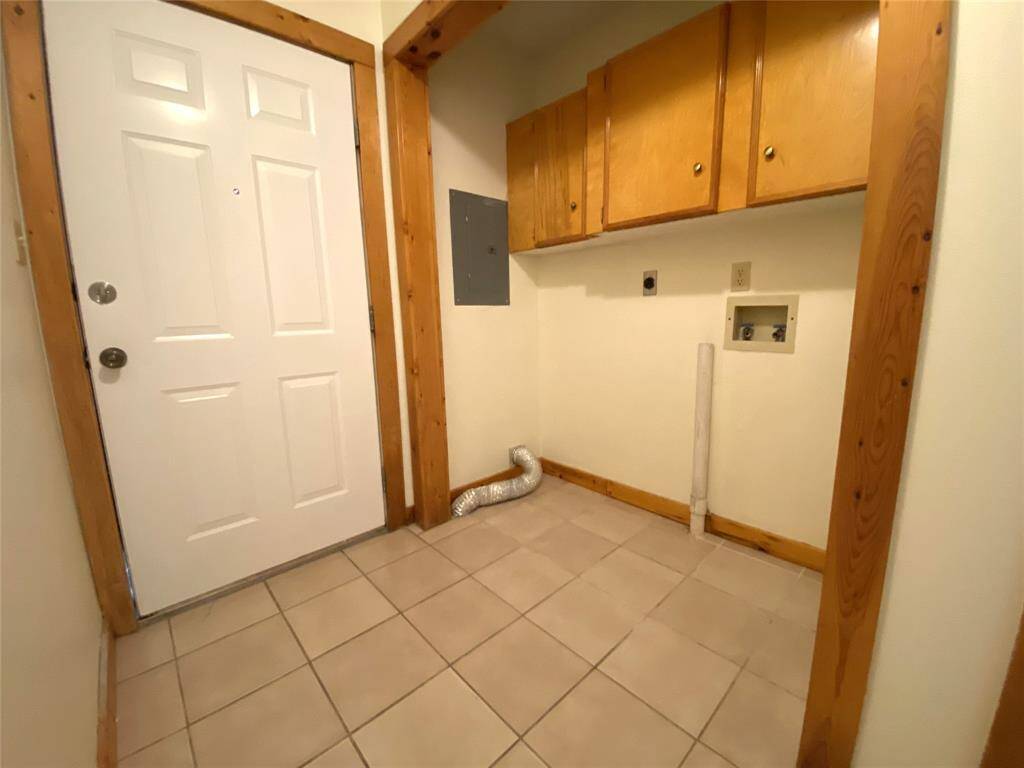 Utility room has cabinet space for added storage.