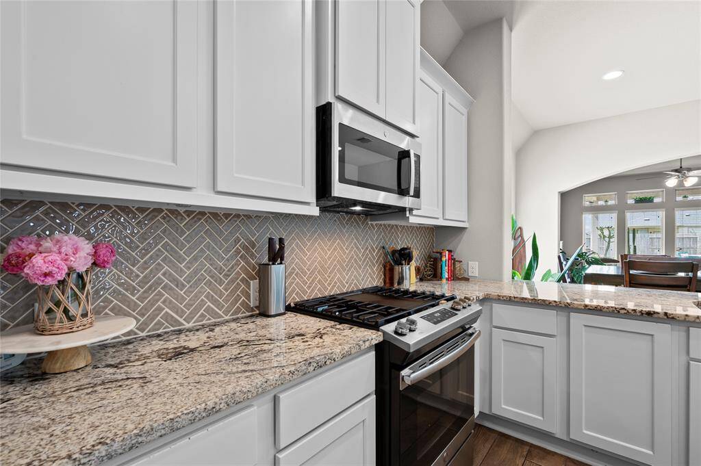 This kitchen features beautiful details and is equipped with a gas range.