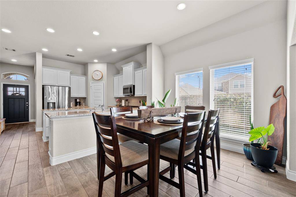 The open-concept floor plan allows you to stay connected to the conversation with a seamless flow from the kitchen, to the dining room and the living room.