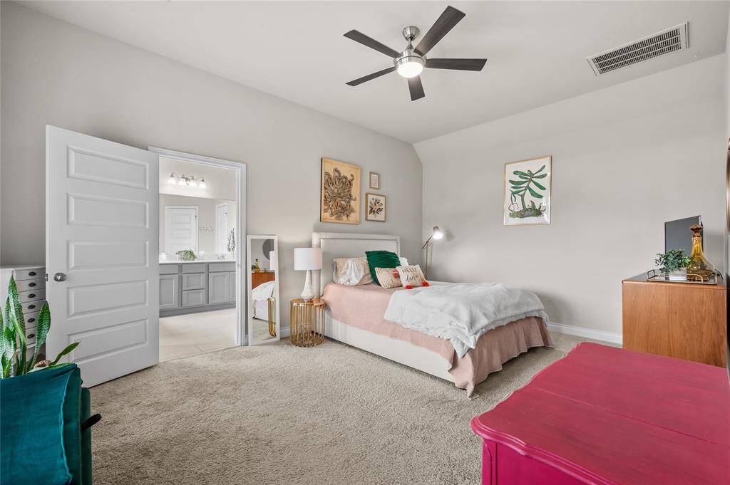 The spacious primary bedroom sits at the back of the house and offers plenty of natural light and privacy!