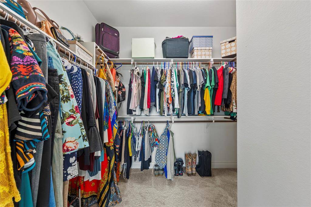 Bedroom 2 sits across from the kitchen and has a large walk-in-closet and an en-suite Jack-and-Jill bathroom.
