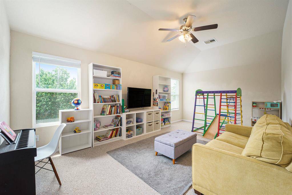 Game room with views of the back yard.