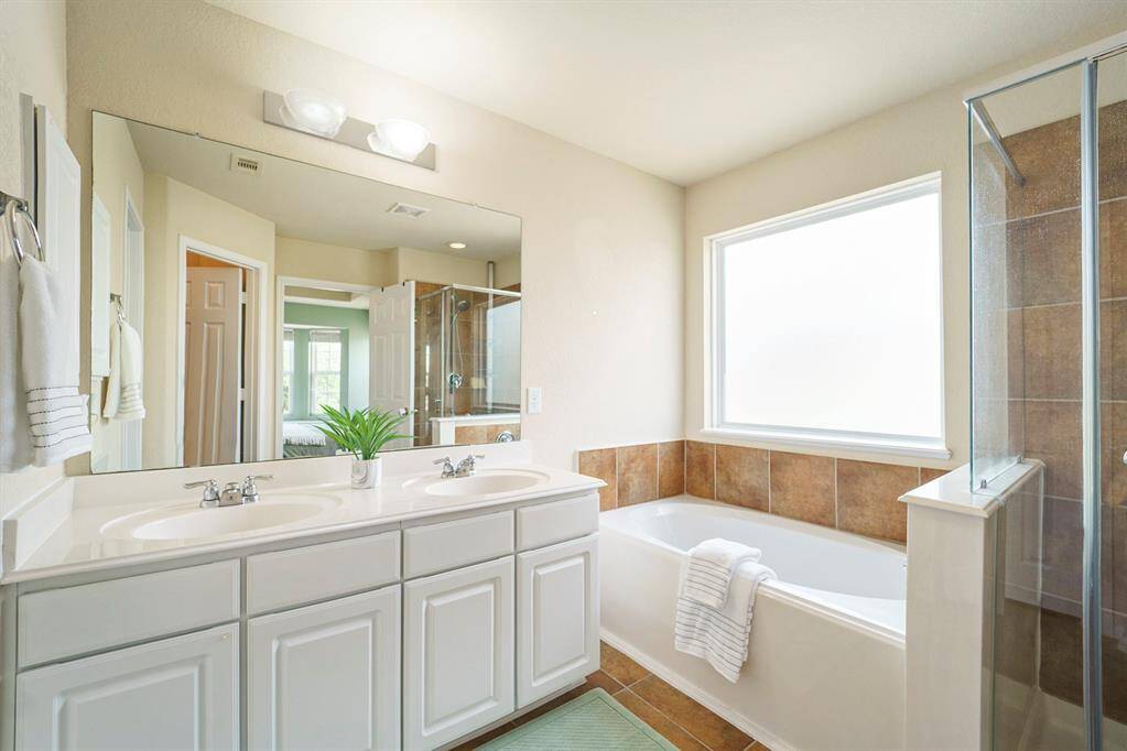 Primary bath, garden tub, separate shower, vanity with double sinks and a large walk-in closet