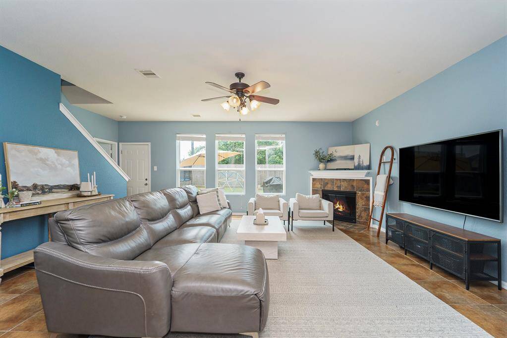 Spacious living room, with a fireplace and views of the backyard.