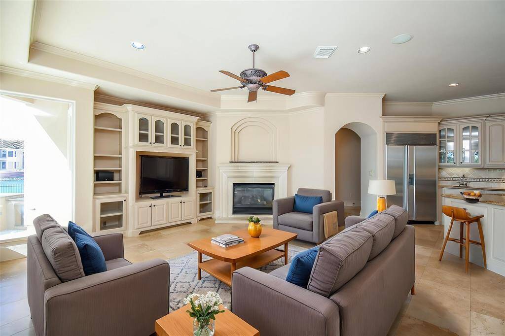 Open family room to the kitchen and breakfast area.  All glass views of the stunning backyard and lake! (virtually Staged)