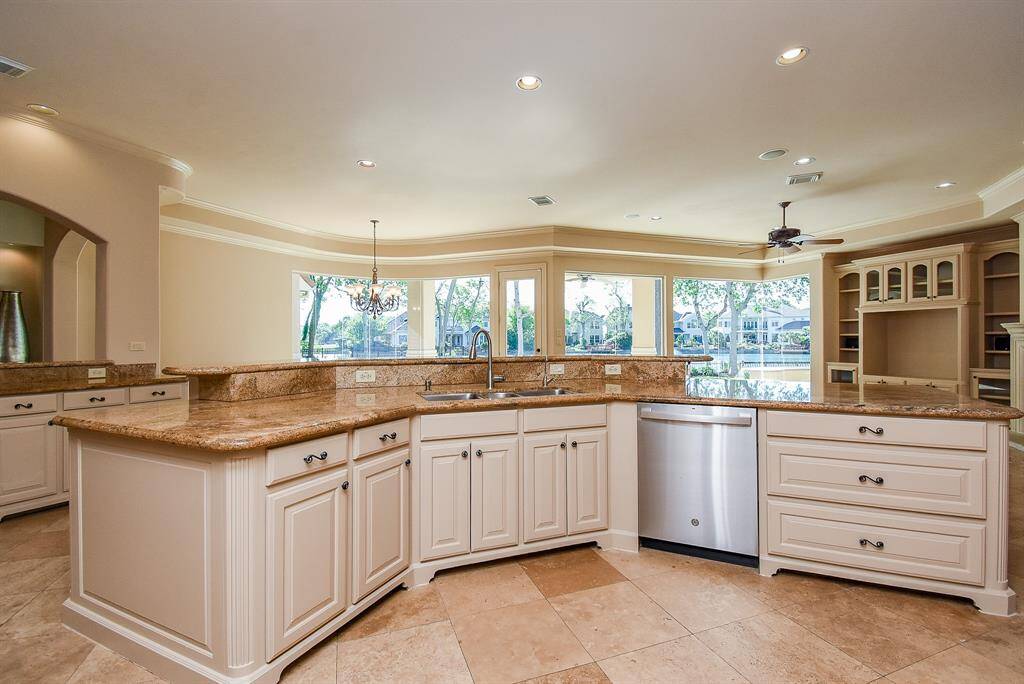 View from kitchen looking into casual dining area and family area. Note the view to the backyard oasis!