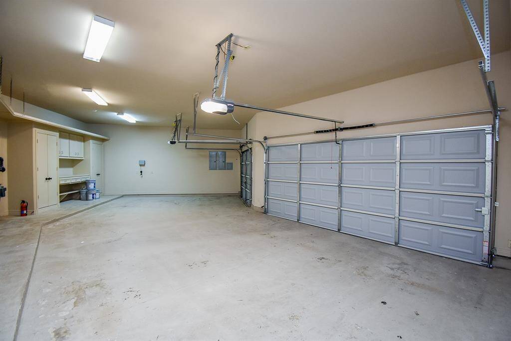 Oversized garage can easily fit 3 cars.